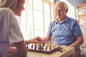 an older man playing chess with a provider